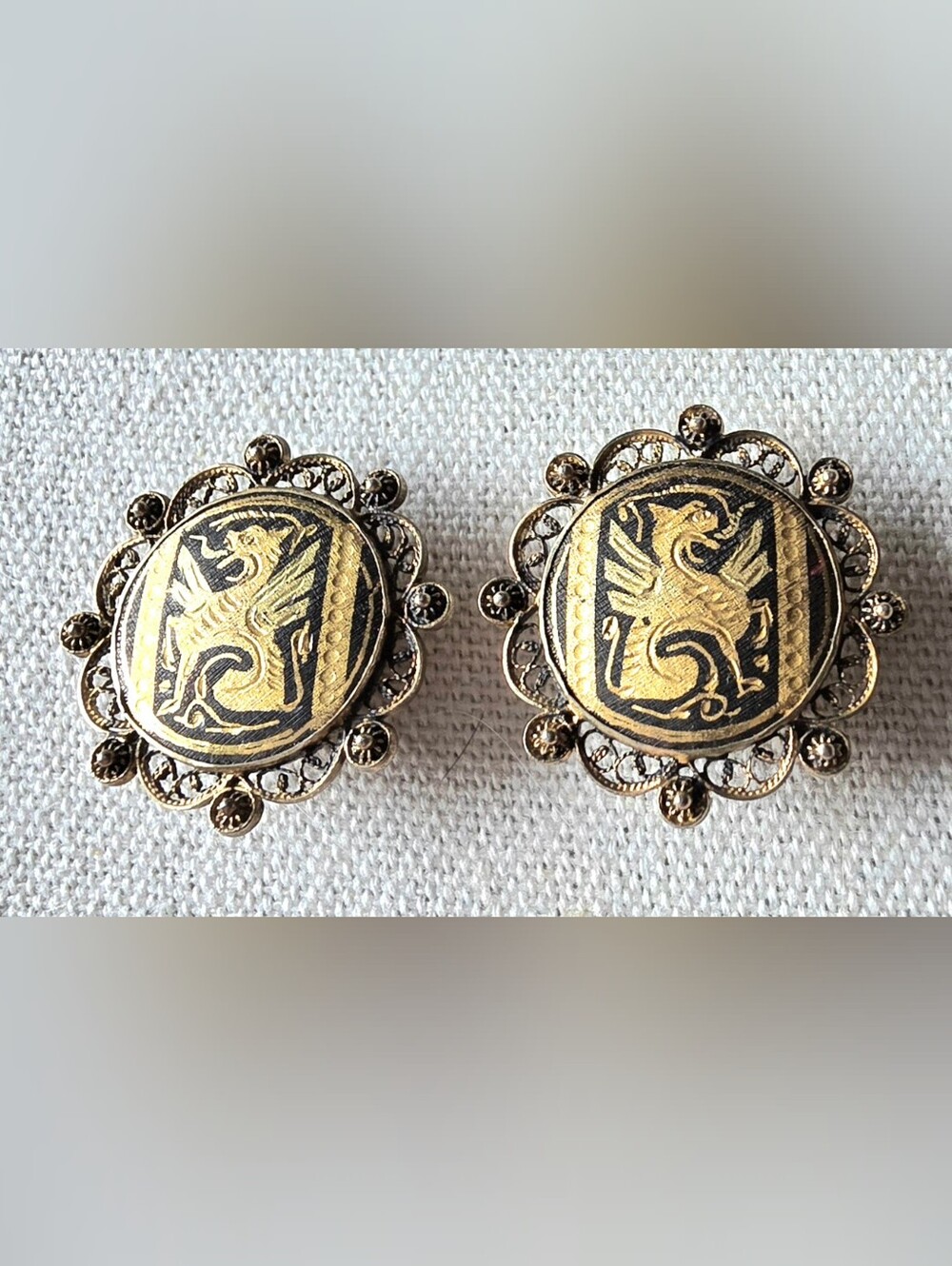 Vintage Spanish Damascene clip-on earrings featuring a classic heraldic griffin.